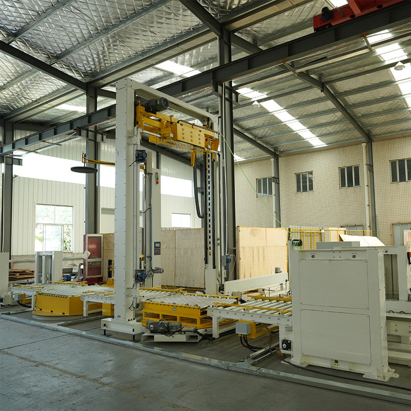 Conveyorized stretch wrapper in factory, built for automated high-volume pallet wrapping.