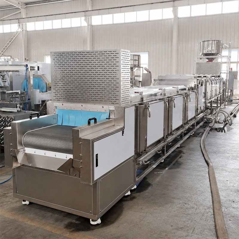 Steam rice cooking line operating in industrial food processing factory