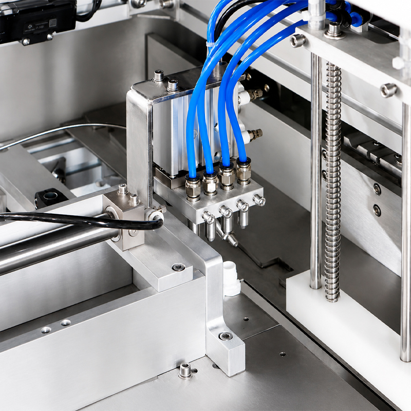 Close-up of four filling heads on spout pouch liquid filling production machine