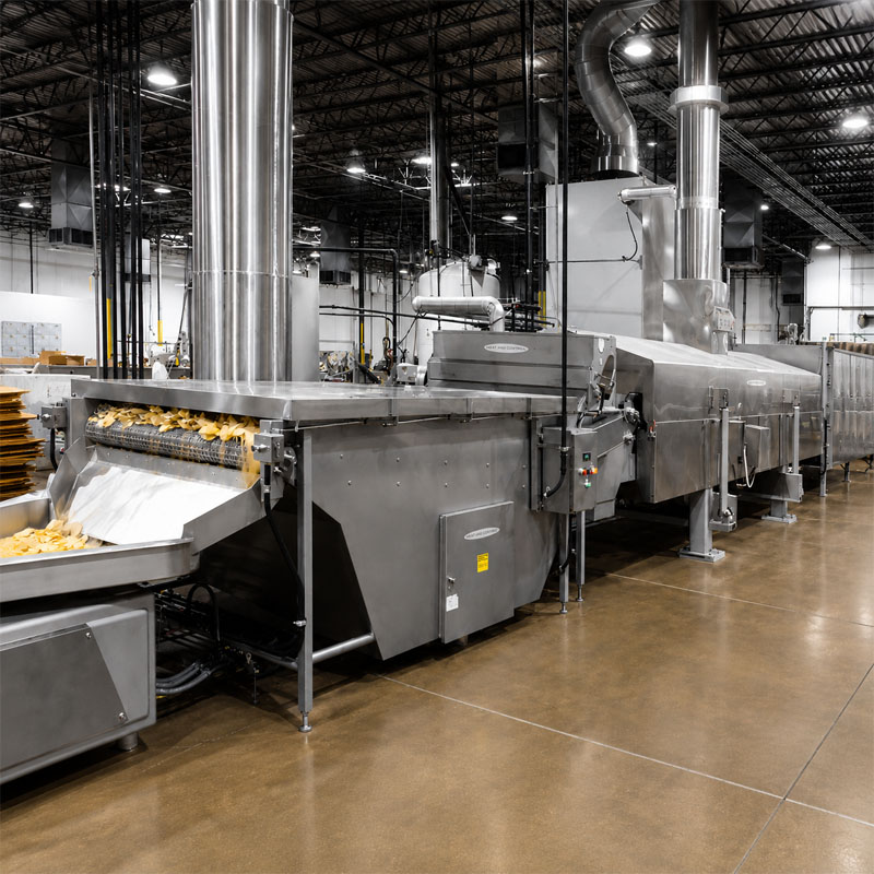 Industrial continuous fryer processing potato chips in production line